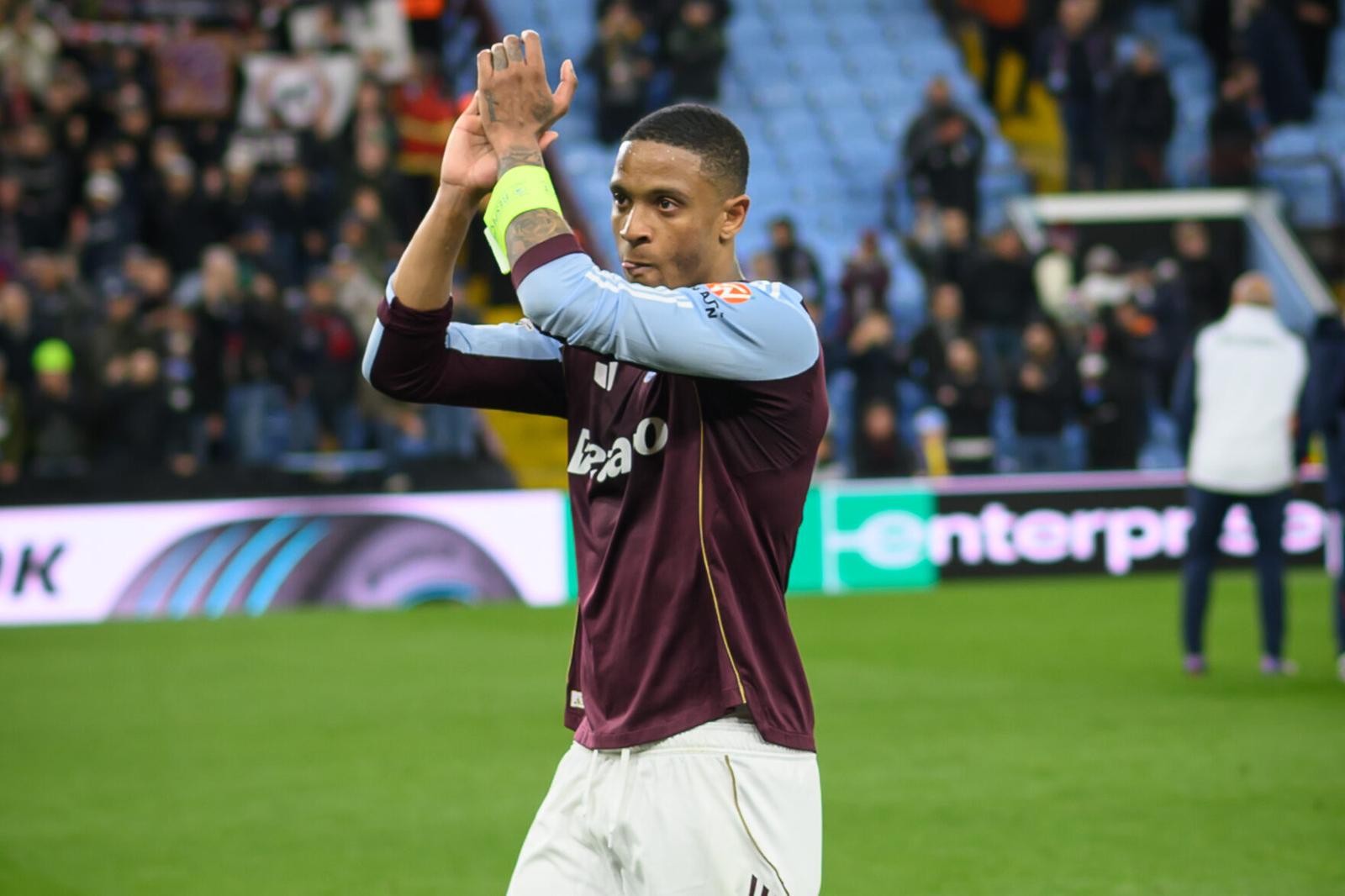 Ezri Konsa claps the fans